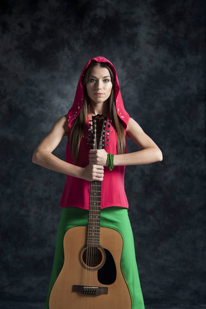 A young girl plays the guitar and sings funny rock and sad romances - Photo, Image