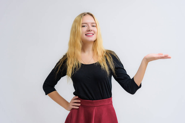 Concept portrait of a beautiful happy blonde girl on a white background smiling and talking with different emotions. She stands directly in front of the camera in various poses. - Fotó, kép