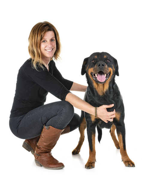 purebred rottweiler and woman in front of white background - 写真・画像