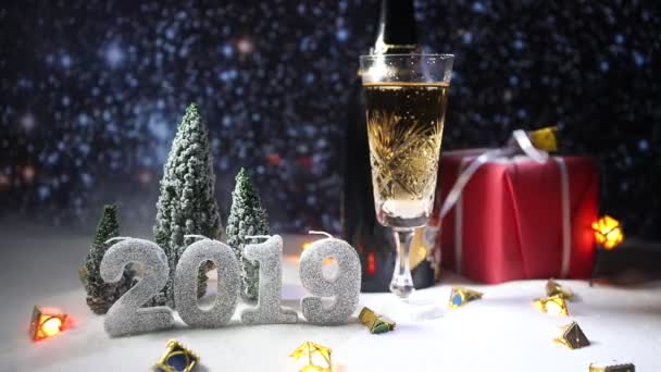 Glass of champagne with Christmas decoration. Traditional winter holiday alcohol drink in snow with creative New Year artwork. Copy space - Footage, Video