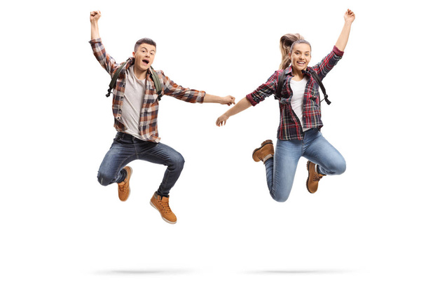 Happy male and female students jumping isolated on white background  - Fotoğraf, Görsel