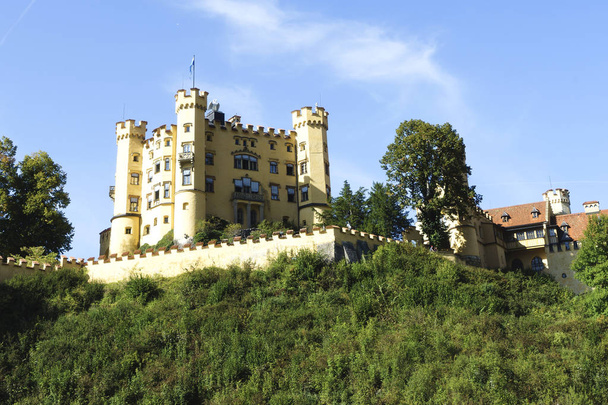Hohenschwangau Castle lies directly opposite the Neuschwanstein Castle in Schwangau in Bavaria. - Photo, Image