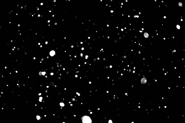 white dots on black snow bokeh background - Foto, Imagen