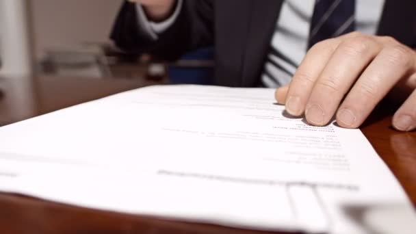 Businessman signing a document. - Video