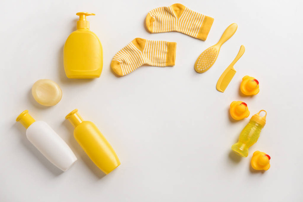 Set of bath cosmetics and baby socks on white background - Photo, Image