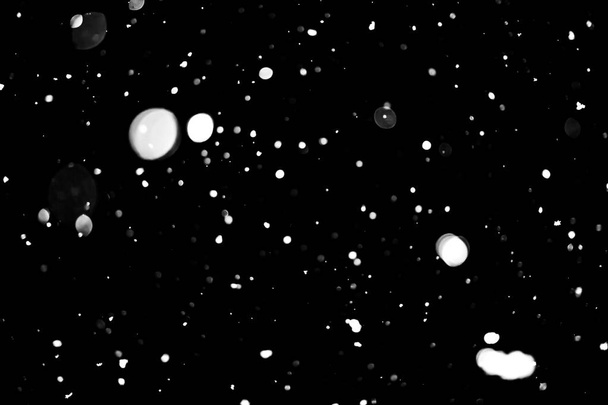 άσπρες κουκκίδες σε μαύρο χιόνι bokeh φόντο - Φωτογραφία, εικόνα
