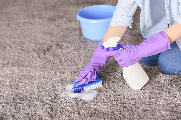 Woman cleaning carpet at home - Photo, Image