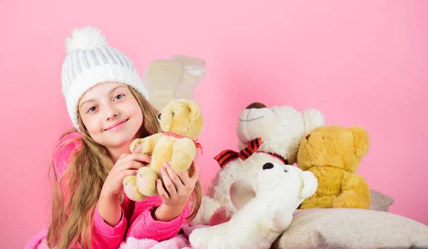 Teddy bears improve psychological wellbeing. Softness is key. Child small girl playful hold teddy bear plush toy. Bears toys collection. Kid little girl play with soft toy teddy bear pink background - Foto, imagen