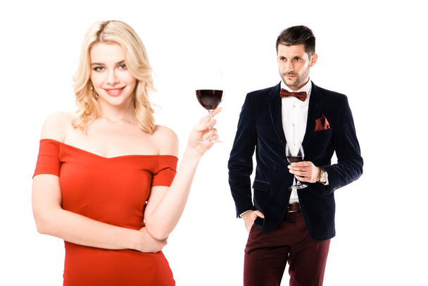 Couple of smiling blonde woman and serious man with glasses of wine isolated on white - Φωτογραφία, εικόνα