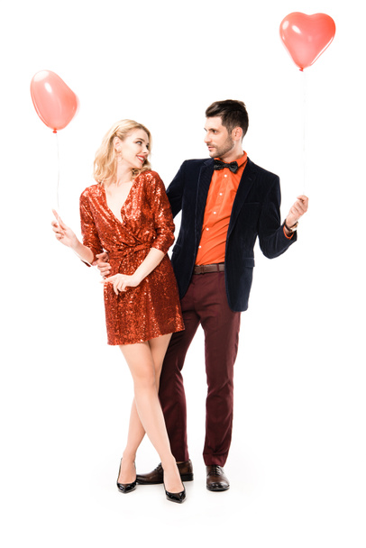 Beautiful romantic couple with red balloons isolated on white - 写真・画像