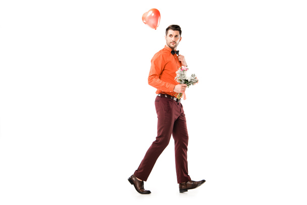 Handsome man with bouquet of flowers and red balloon isolated on white - Photo, Image