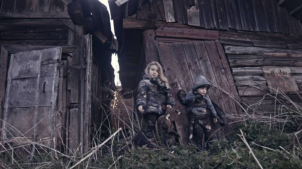 portrait of little dirty homeless kids beside abandoned building - Фото, зображення