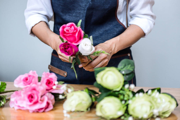 Arranging artificial flowers vest decoration at home, Young woman florist work making organizing diy artificial flower, craft and hand made concept. - Photo, Image