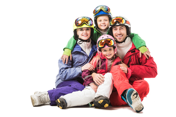 Happy family sitting and hugging in snowsuits isolated on white - Foto, Bild