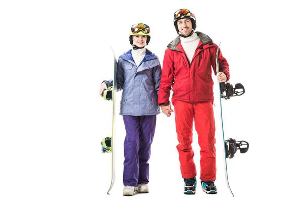 coppia in abiti da sci con snowboard che si tiene per mano e guardando la fotocamera isolata su bianco
 - Foto, immagini