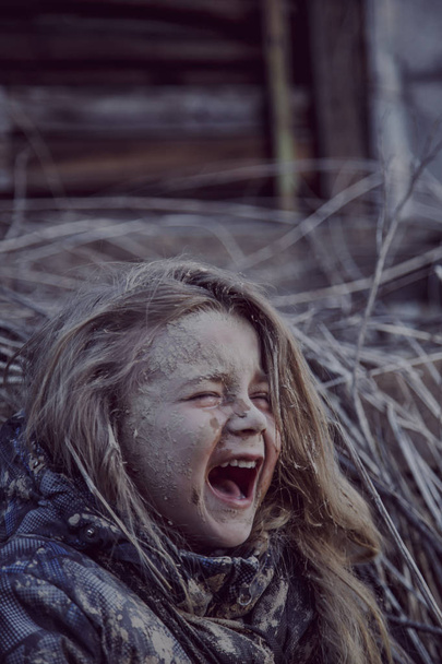 portrait of dirty little homeless girl crying - Photo, image