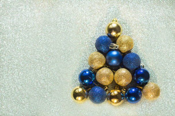 new year christmas decoration balls blue golden triangle shape of balls gray shiny background - Фото, зображення