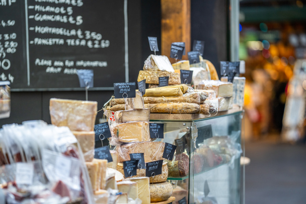 LONDON, UK - NOVEMBER 13, 2018 - Cheese and other quality Italian products such as Salami at London's famous markets located near the Borough Market - Photo, Image
