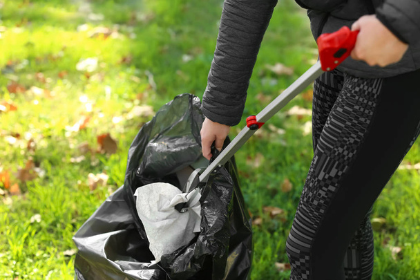 Woman gathering trash in park - Zdjęcie, obraz