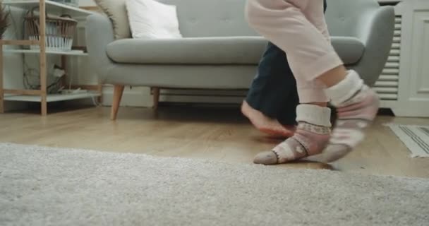 Home style couple dancing in the living room closeup capturing legs. - Materiał filmowy, wideo