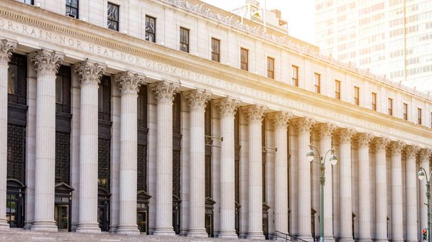Rows of columns align the entrance to the historic New York City Post Office building in Manhattan NYC - 写真・画像
