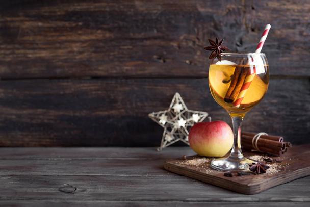 Hard apple cider (sangria, punch, fruit wine) for autumn and winter holidays - homemade festive Christmas, Thanksgiving drink on wooden table, copy space. - Zdjęcie, obraz