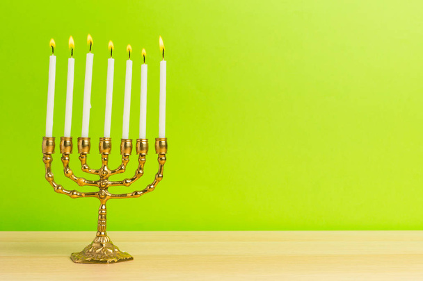 Bronze Hanukkah menorah with burning candles - Valokuva, kuva