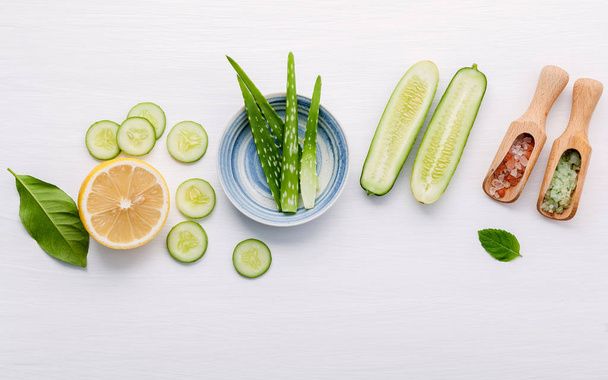 Natural herbal skin care products. Top view ingredients cucumber ,aloe vera ,lemon and himalayan salt on table concept of the best all natural face moisturizer. Facial treatment preparation background. - Photo, Image