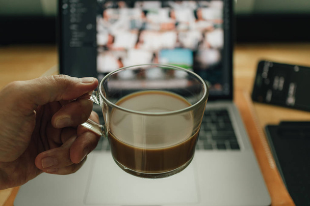 Coffee and Laptop on freelance work desk in warm light. - 写真・画像