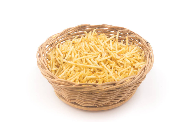 Potato Sticks in a basket bowl. Batata Palha isolated on white background - Foto, imagen