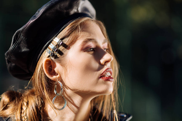Fashionable model wearing leather beret participating in photo session - Фото, зображення
