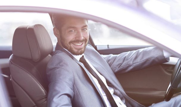 Handsome businessman in the drivers seat in his car - Photo, Image