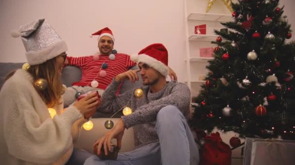 Three friends sharing Christmas / New Year's eve  presents. - Felvétel, videó