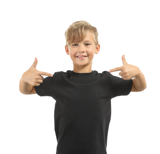 Cute boy pointing at his t-shirt on white background - Фото, изображение