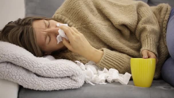 Sick girl holding tissue and holding stomach and tea. - Footage, Video
