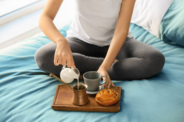 Young woman having delicious breakfast on bed - Photo, Image