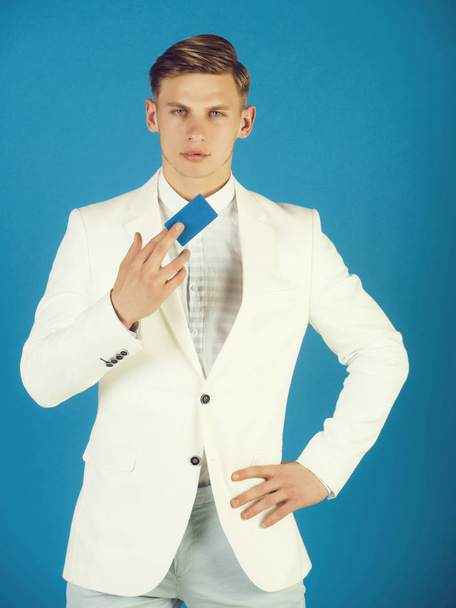 Businessman posing in white jacket, shirt and pants - 写真・画像
