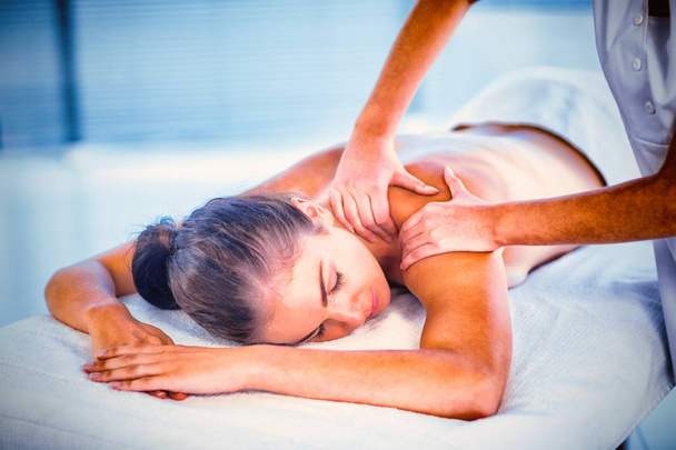 Relaxed naked woman receiving back massage at spa - Photo, image