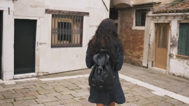 Attractive girl walks through the narrow streets of Venice - Materiał filmowy, wideo