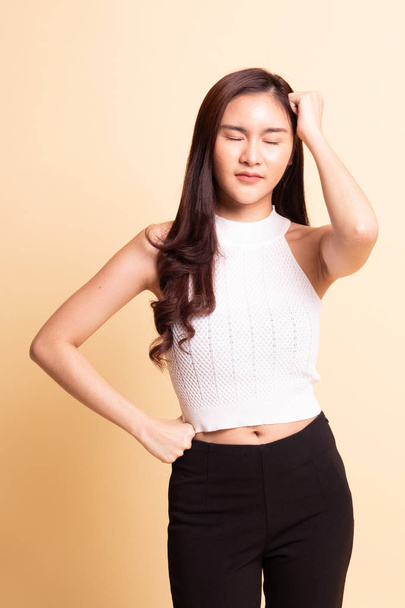 Young Asian woman got sick and  headache   on beige background - Foto, Imagem