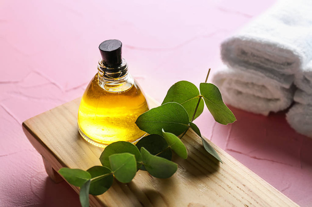 Bottle of eucalyptus essential oil on wooden stand - Photo, Image