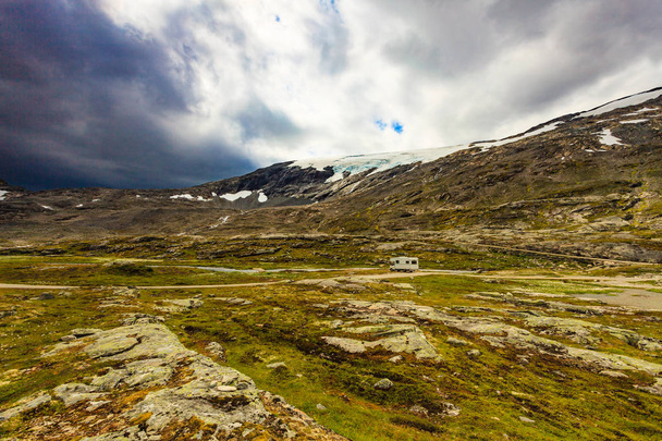 Camper car in norwegian mountains. Camping on nature. Traveling, holidays and adventure concept. - Fotografie, Obrázek