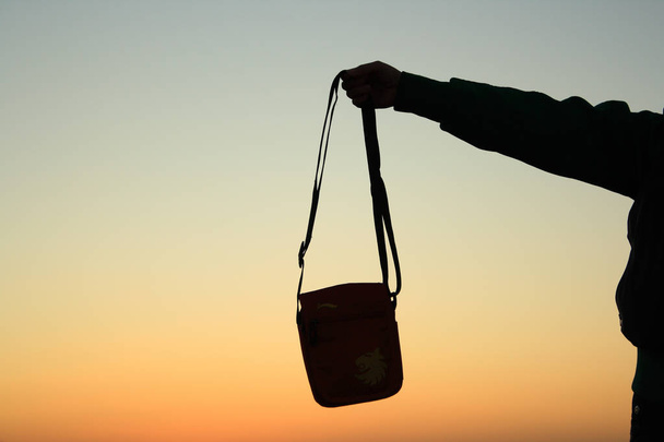 Holding an bag silhouette - Photo, Image