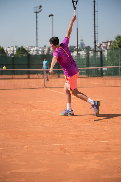 Young tennis player playing backhand - Fotoğraf, Görsel