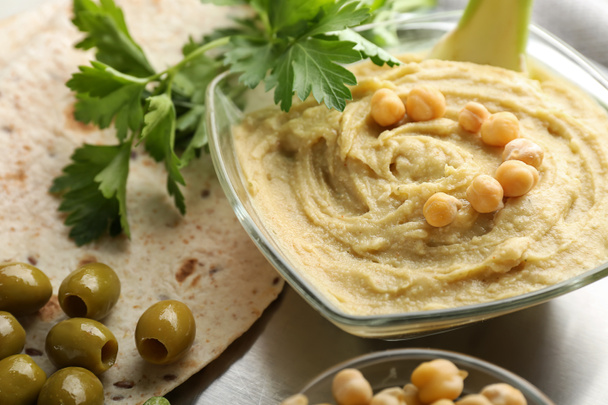 Bowl with tasty hummus and flatbread on metal tray, closeup - Photo, Image