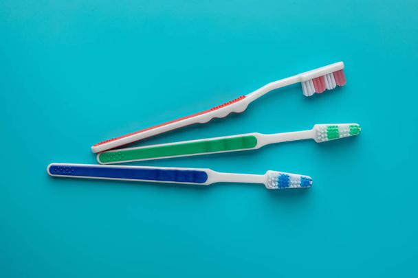 Toothbrushes on blue background. object shaped pieces. - Fotoğraf, Görsel