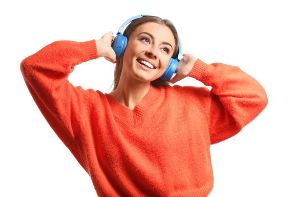 Beautiful woman listening to music on white background - Φωτογραφία, εικόνα
