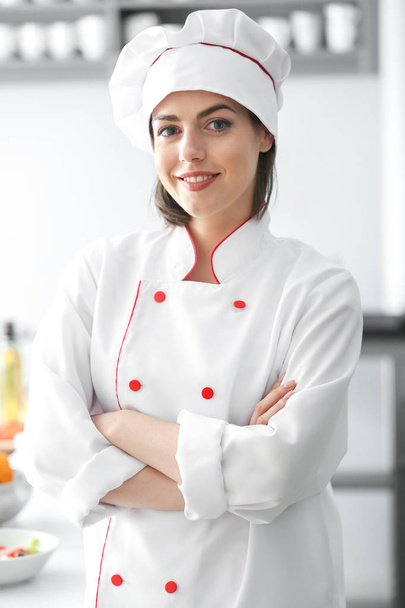 Young female chef in kitchen - 写真・画像