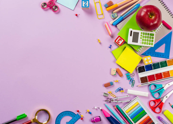 Top view of school and office supplies on colorful background - Foto, afbeelding