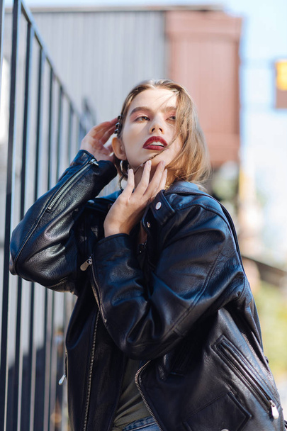 Dark-eyed trendy model wearing leather jacket and beret posing - Fotografie, Obrázek